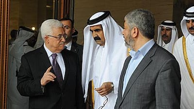 The emir of Qatar, Sheikh Hamad Bin Khalifa Al Thani, ushers the Palestinian Authority president Mahmoud Abbas, left, and the Hamas leader Khaled Mashaal into a ceremony to sign an entente in Doha yesterday.