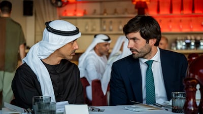 Sheikh Hamdan bin Mohamed, Deputy Chairman of the Presidential Court for Special Affairs, speaks to a guest during the dinner reception