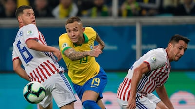 Brazil's Everton drives the ball past Paraguay's Richard Sanchez, left, and Ivan Piris. AFP