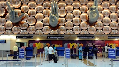 Transit passengers pass through immigration counters at Terminal T-3 of Indira Gandhi International Airport in New Delhi. Tourists travelling to India from 180 countries will no longer have to queue at their local consulates to obtain visas after New Delhi announced a 'very significant' overhaul of its border controls. Prakash Singh / AFP