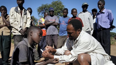 A Zambian healthcare worker tests for malaria in a rural village during one of the Roll Back Malaria Partnership's programmes. Malaria kills about 430,000 people every year. Thierry Roge / Reuters