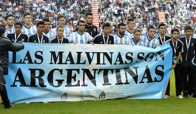 Argentina's footballers pose for photographers holding a banner reading "The Malvinas / Falkland Islands are Argentine" before a friendly against Slovenia at La Plata stadium in La Plata, Buenos Aires, Argentina on June 7, 2014. AFP