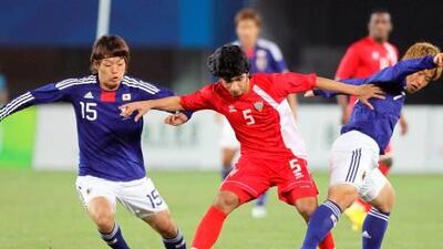 The UAE's Amer Abdulrahman tries to hold off Keigo Higashi, left, and Ryohei Yamazaki of Japan.