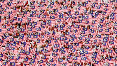 Malaysian children wave national flags during an Independence Day celebration rehearsal in Putrajaya, Malaysia. EPA