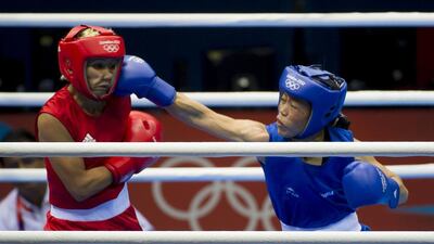 MC Mary Kom, left, competes against Maroua Rahali of Tunisia during the flyweight quarter-finals at the 2012 London Olympic Games. Jonathan Short / AP Photo