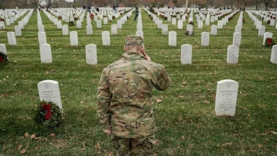 A US Army soldier salutes after laying a wreath during the 30th annual event to lay wreaths on more than 253,000 headstones of the US military service members buried at Arlington National Cemetery in Arlington, Virginia. Reuters