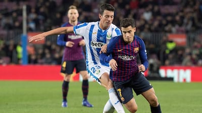 Barcelona midfielder Philippe Coutinho tussles with Mikel Vesga. EPA