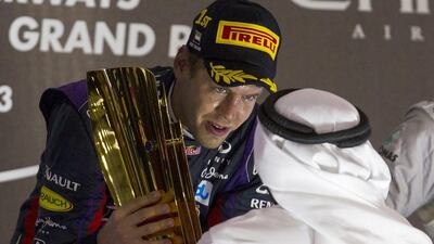 Sebastian Vettel, who won his seventh straight race of the F1 season, receives the victor's trophy on Sunday.
