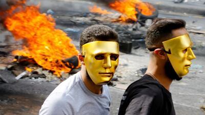 Marwan Tahtah's eerie photograph of masked protestors, 'Revolution in Lebanon', taken on October 17, 2019, is emblematic of the raw imagery produced during the country's recent unrest. Courtesy of the artist