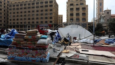 People dismantle tents after Lebanese security forces cleared away a protest camp and reopened roads blocked by demonstrators since protests against the governing elite started in October, in Beirut. REUTERS