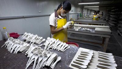 Above, workers at the porcelain production line of RAK Ceramics. Jaime Puebla / The National