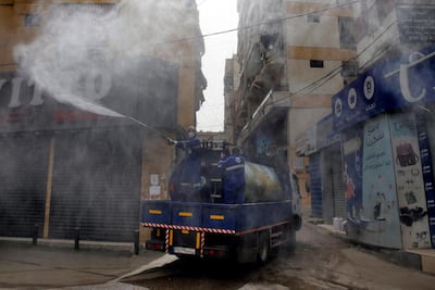 In this March 27, 2020 photo, members of the Islamic Health Society, an arm of the Iran-backed militant Hezbollah group sprays disinfectants as a precaution against the coronavirus, in a southern suburb of Beirut, Lebanon. AP Photo