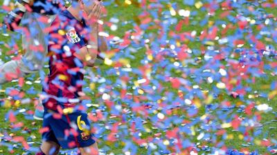 Barcelona's Xavi reacts as his team are awarded the La Liga trophy following his final league match with the club on Saturday. Josep Lago / AFP