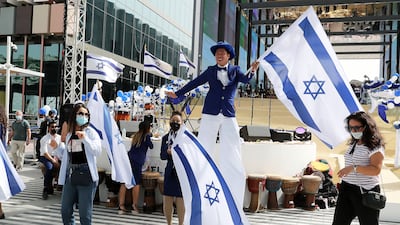 Performers and staff members hold Israeli flags at the Israel day celebration at Expo 2020 Dubai. All photos: Pawan Singh / The National