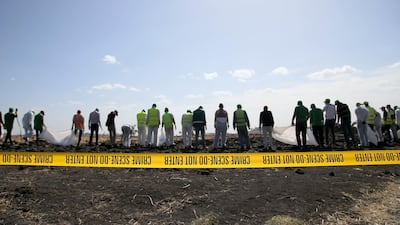 Forensic investigators and recovery teams collect personal belongings and other material from the crash site of Ethiopian Airlines Flight ET 302 in Bishoftu, Ethiopia. Getty Images