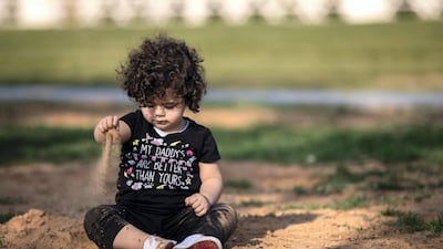 A youngster plays in the sand on Friday afternoon