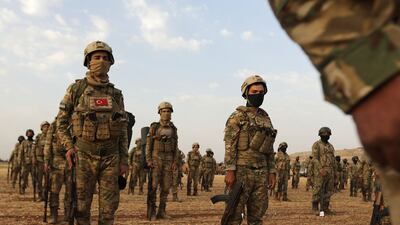 Fighters gather in Manbij, Aleppo, one of the areas that Turkey plans to target in its incursion.