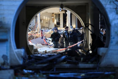 Israeli security personnel gather at the site of an Iranian missile attack on Arad. Reuters