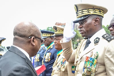 General Brice Oligui Nguema, right, pictured at an Independence Day ceremony before last week's coup. AFP