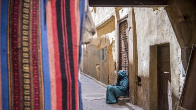 A woman sits in the 9th century walled medina in the ancient Moroccan city of Fez on April 11, 2019. AFP