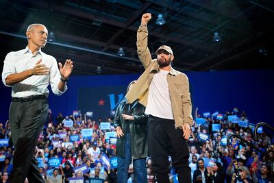 Eminem with Barack Obama at a campaign rally supporting Harris in his home city of Detroit. AP