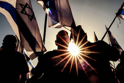 Israeli military veterans wave national flags during a rally against the government's judicial reform bill in March. AFP