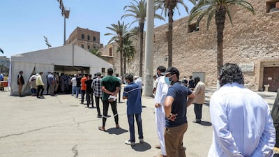 People queue at a coronavirus vaccination and testing centre at the Martyrs' Square of Libya's capital Tripoli.