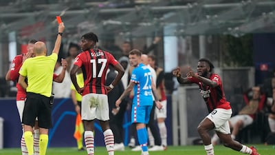 AC Milan's Franck Kessie, right, is shown a red card. AP