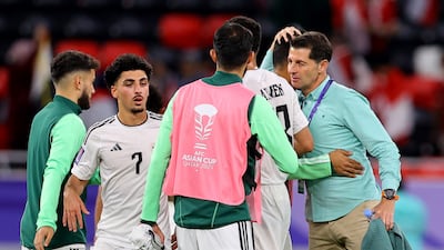 Iraq coach Jesus Casas, right, celebrates with his players after their Asian Cup Group D victory over Indonesia. Reuters