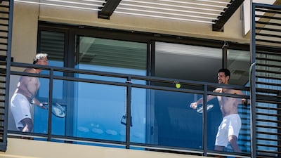 World No 1 Novak Djokovic plays tennis on the balcony of his apartment with a member of his coaching team while in quarantine in Adelaide ahead of the Australian Open Grand Slam tournament, on Wednesday, January 20. AFP