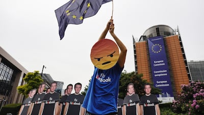 A protester in Brussels last month, when Facebook co-founder Mark Zuckerberg appeared before the EU. Dario Pigantelli / Bloomberg