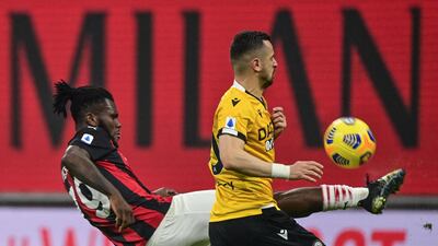 AC Milan's Ivorian midfielder Franck Kessie and Udinese's North Macedonia forward Ilja Nestorovski go for the ball. AFP