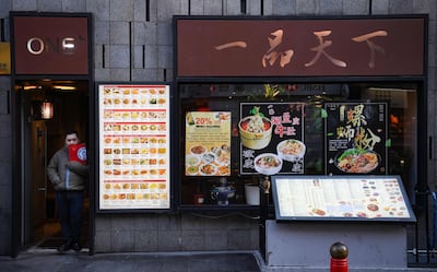 A worker waiting for customers in London's Chinatown district. AFP