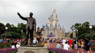 Visitors stroll along Main Street at Walt Disney World in Lake Buena Vista, Florida. A new service lets those with the cash get a sneak preview of upcoming attractions. John Raoux/AP