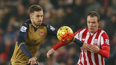 Arsenal midfielder Aaron Ramsey, left, battles for the ball with Stoke midfielder Glenn Whelan. Lee Smith / Reuters
