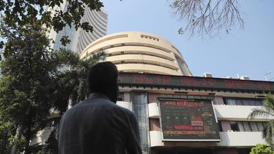 A man watches the stock exchange index on a display screen during India's Union Budget announcement earlier this month. The country's economy is on course to grow at its slowest rate in a decade in the financial year ending March 31. AP Photo