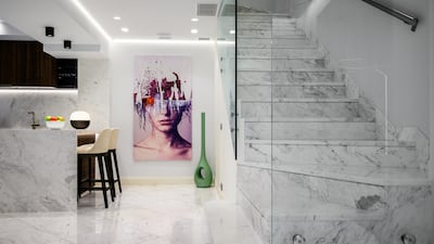 The open-plan kitchen leads to the dining and living areas