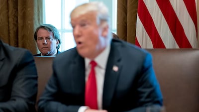 White House counsel Donald McGahn, left, listens as President Donald Trump speaks during a cabinet meeting. AP