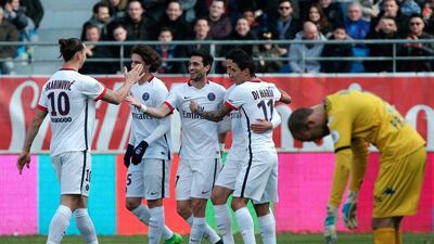 PSG's Javier Pastore, center, celebrates with teammate after scoring, as Troyes' goalkeeper Matthieu Dreyer, right, reacts during their Ligue 1 match in Troyes, France, Sunday, March 13, 2016. (AP Photo/Thibault Camus)