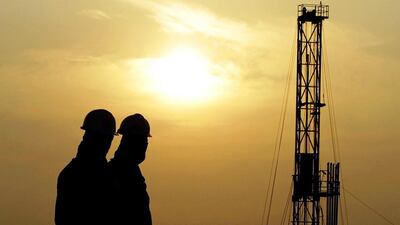 Oil workers stand at a facility site in the desert oil fields of Sakhir, Bahrain. Crude oil prices stood at US$34 per barrel at the beginning of 2009 and little more than $20 per barrel in 2000. Hasan Jamali / AP Photo