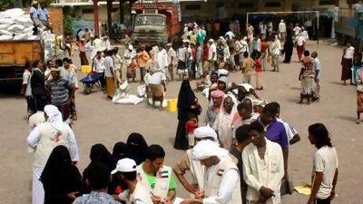 :Emirati aid workers distribute food donated by the UAE in the southern city of Aden last week to Yemenis who fled Abyan province following clashes between government forces and fighters allied with Al Qaeda.