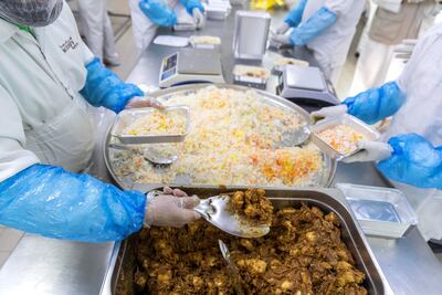 Meal preparation for handing out as part of charity at Modern Bakery in Al Quoz, Dubai, on April 27, 2020. Antonie Robertson / The National