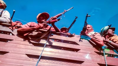 A picture taken through a car window shows Ethiopian Amhara militia fighters, that combat alongside federal and regional forces against northern region of Tigray, as they mobilise towards Tigray, in the Northwest of the city of Gondar, Ethiopia, on November 09, 2020. AFP / EDUARDO SOTERAS
