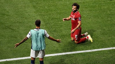 Mohamed Salah of Liverpool and substitute Erik Lamela of Tottenham Hotspur share a joke during the UEFA Champions League Final. Getty