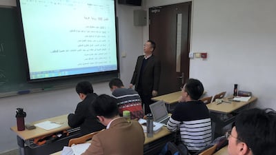 Dr. Lin Feng Min, Director of the Arabic Department of Peking University, teaching students Arabic. (Lu-Hai Liang for The National)