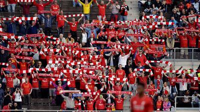 Liverpool fans wave flags during their team’s game against HJK Helsinki. Adam Holt / Reuters