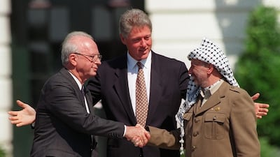 Assassinated Israeli ex-prime minister Yitzhak Rabin, left, and the late Yasser Arafat, with former president Bill Clinton during the 1993 Oslo peace accords in Washington, DC. Ron Edmonds / AP