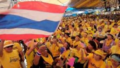 Protesters wave a national flag inside the Government House in Bangkok yesterday.
