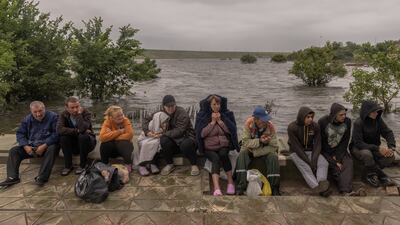 People wait for a transfer on a pontoon in a flooded area as the result of the Kakhovka dam destruction in June 2023 in Afanasiivka village, Mykolaiv region. Getty Images