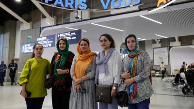 From left, English teacher Hafsa, Najla Latif, president of a science faculty, Naveen Hashim, researcher and women's rights activist, Zakia Abasi, former employee of a beauty salon and TV journalist Muzhgan Feraji arrive at Charles de Gaulle airport in Paris. AFP
